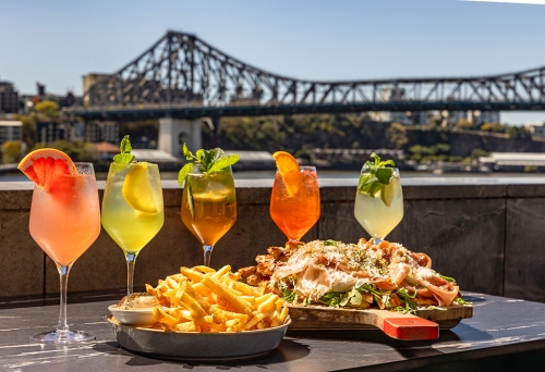 Cocktails and food in front of the Story Bridge