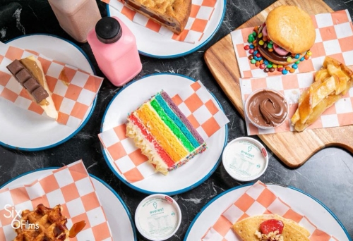 Cakes and desserts on plates at Sweet Tooth Gelato & Desserts Hawthorne