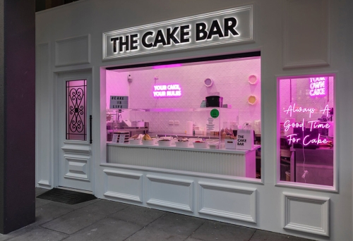 Lit up facade of The Cake Bar