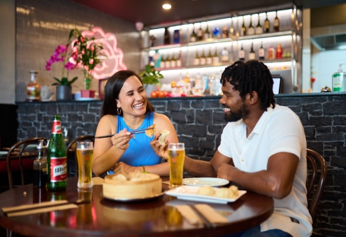 Two people enjoying food in a restaurant, Nicholas Street Precinct Dining