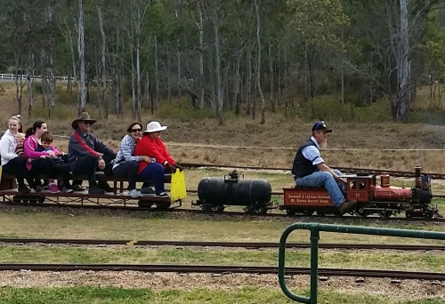 Passengers riding model steam train Grandchester Model Steam Railway Ipswich