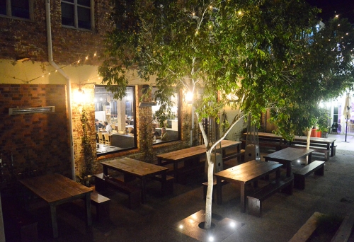 Courtyard seating at night outside Heisenberg Haus, Ipswich