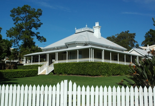 Hughesville house and front yard behind a white picket fence in Eight Mile Plains