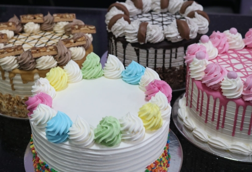 Selection of pink white & caramel sponge cakes 