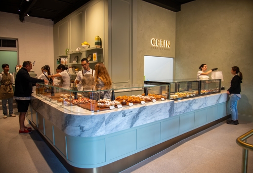 People standing inside counter at of pastries at Cerin Pasticceria Woolloongabba