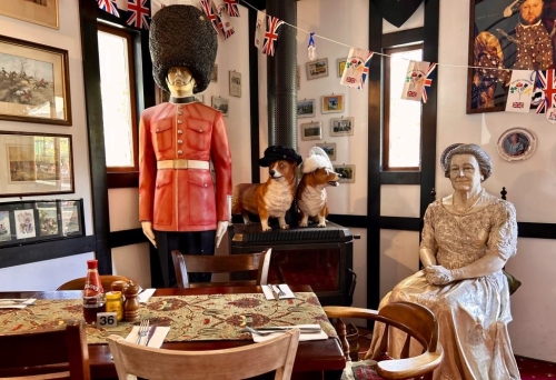 Prince Charles and Queens Elizabeth statues inside the Fox & Hounds Country Inn