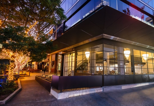 Exterior lit up Facade of Petite Restaurant