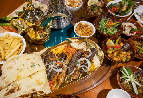 Cedars Restaurant interior with plates of food on table
