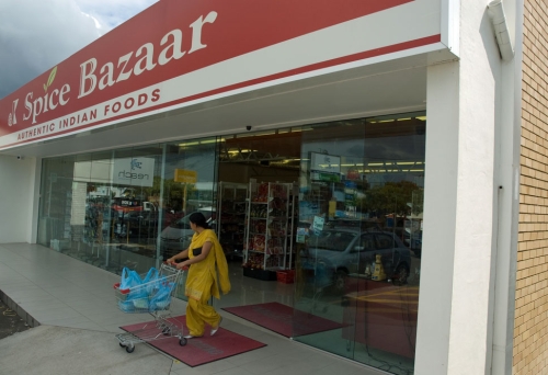 Indian woman in sari pushing tolley out of JK Spice Bazaar in Mt Gravatt