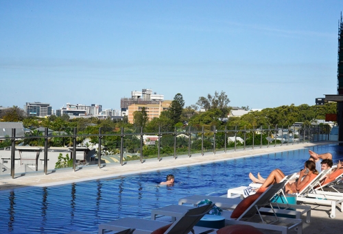 Person swimming in the 50m infinity lap pool at The Johnson Spring Hill