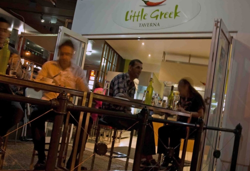 People dining on tales outside Little Greek Taverna West End 