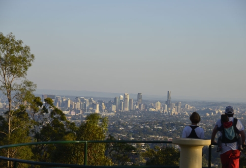 People standing on Mt Gravatt Lookout with views on to Brisbane city buildings. 