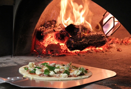 Pizza on a tray outside wood-fired pizza oven at Pizzeria 1760 Yeronga