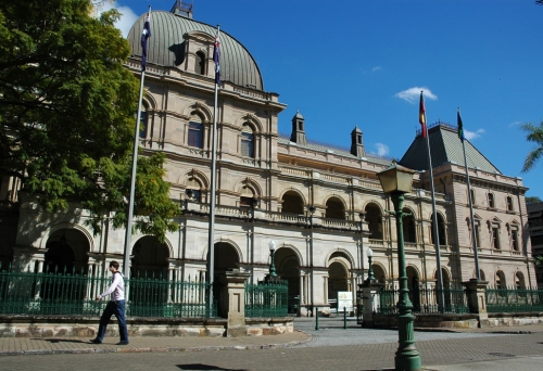 Man walking in front of Parliament House on Alice St Brisbane