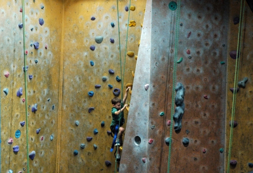 Boy climbing artificial rock wall inside Rocksports Indoor Climbing in Fortitude Valley