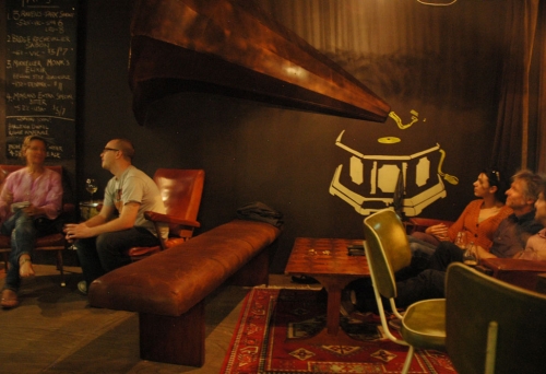 Large gramophone speaker on wall with people sipping beer inside The Scratch Bar in Brisbane'sMilton