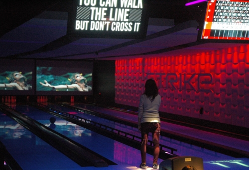 Woman on bowling alley inside Strike Bowling Bar in the Wintergarden mall in Brisbane.