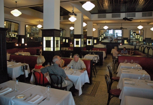 Diner in large brasserie style dining room inside Tartufo Ristorante Wine Bar in Brisbane's Fortitude Valley