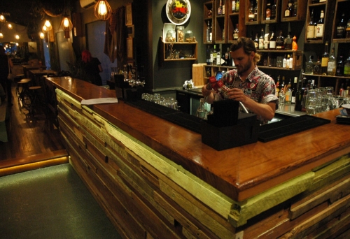 Barman mixing drinks at bar insideThe End Bar in Brisbane's West End 