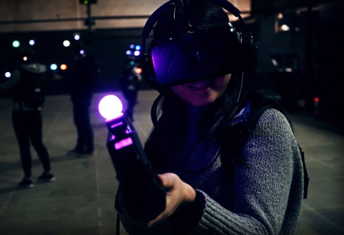 Woman pointing virtual reality equipment at Zero Latency