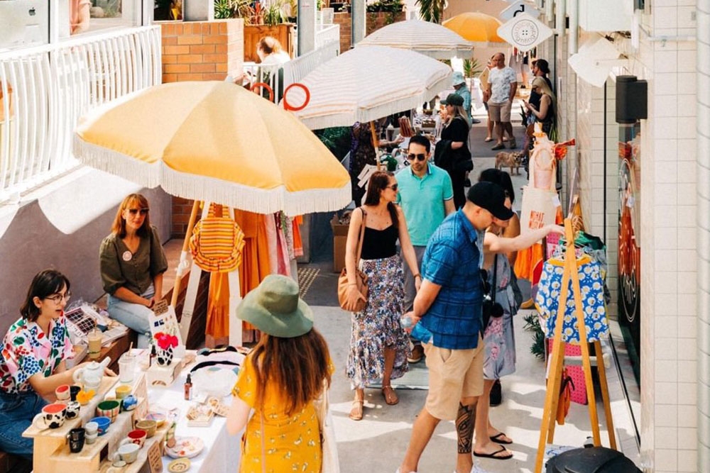 People enjoying the shops and eateries in California Lane 