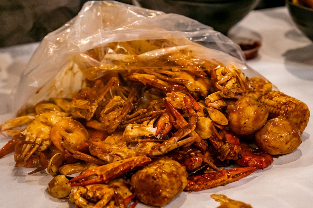 Plastic bag opening a pile of crab pieces