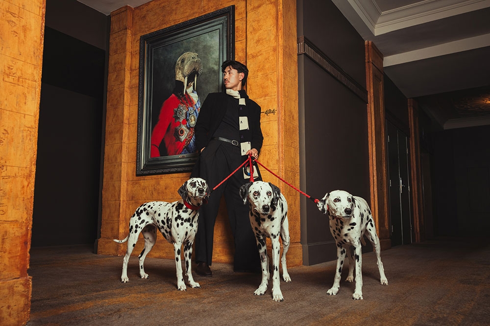 Man in foyer with dalmatians 