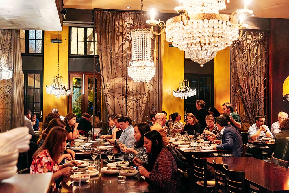 Diners at table inside of Libertine 