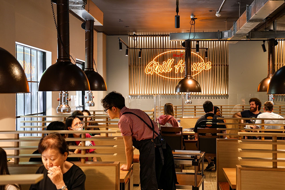 Wait staff talking with diners inside Maru Grill House Brisbane CBD
