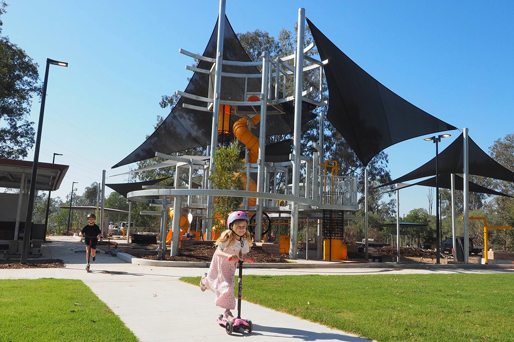 Child playing in playground, Archerfield Wetlands District Park