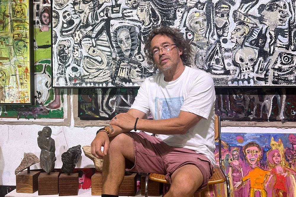 Carlos Barrios in front of his art pieces at his ‘Heart Songs’ Exhibition at Mitchell Fine Art