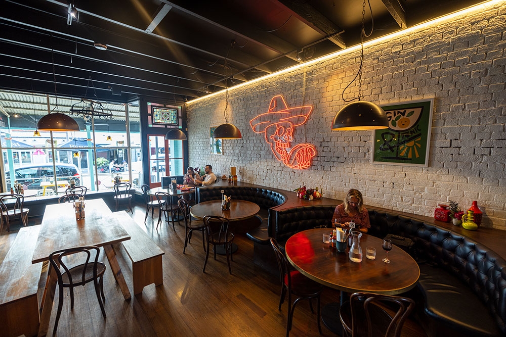 People sitting at tables inside La Carmela Petrie Terrace