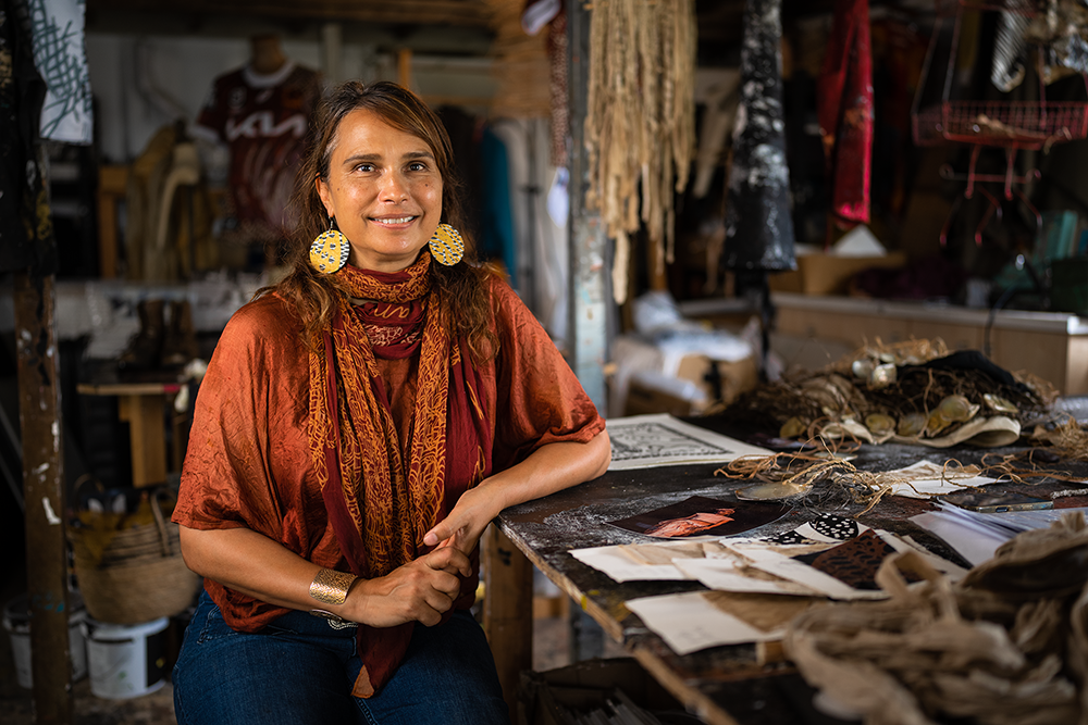 Artist Delvene Cockatoo-Collins sitting in her studio