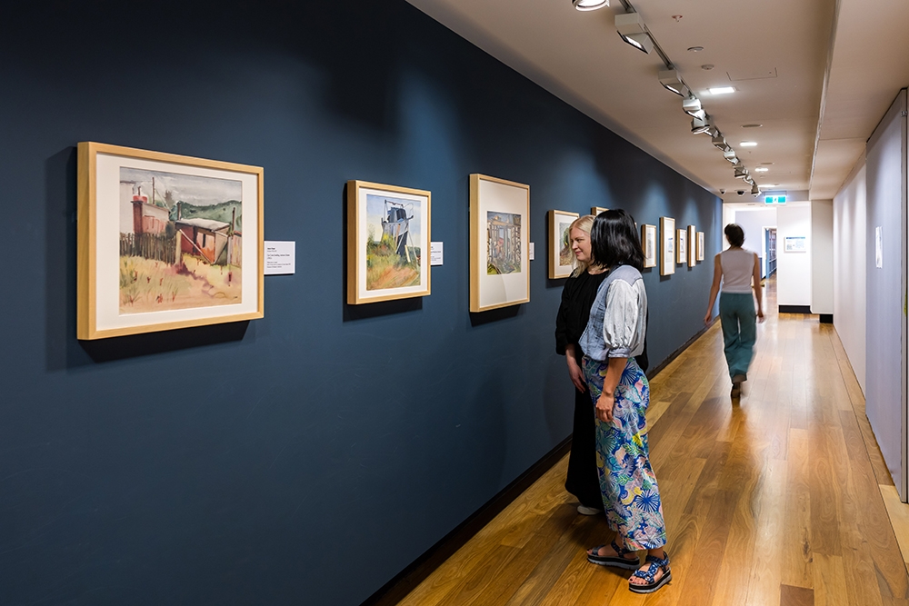 People looking at Cribb Island: Brisbane's Lost Suburb Exhibition at Museum of Brisbane