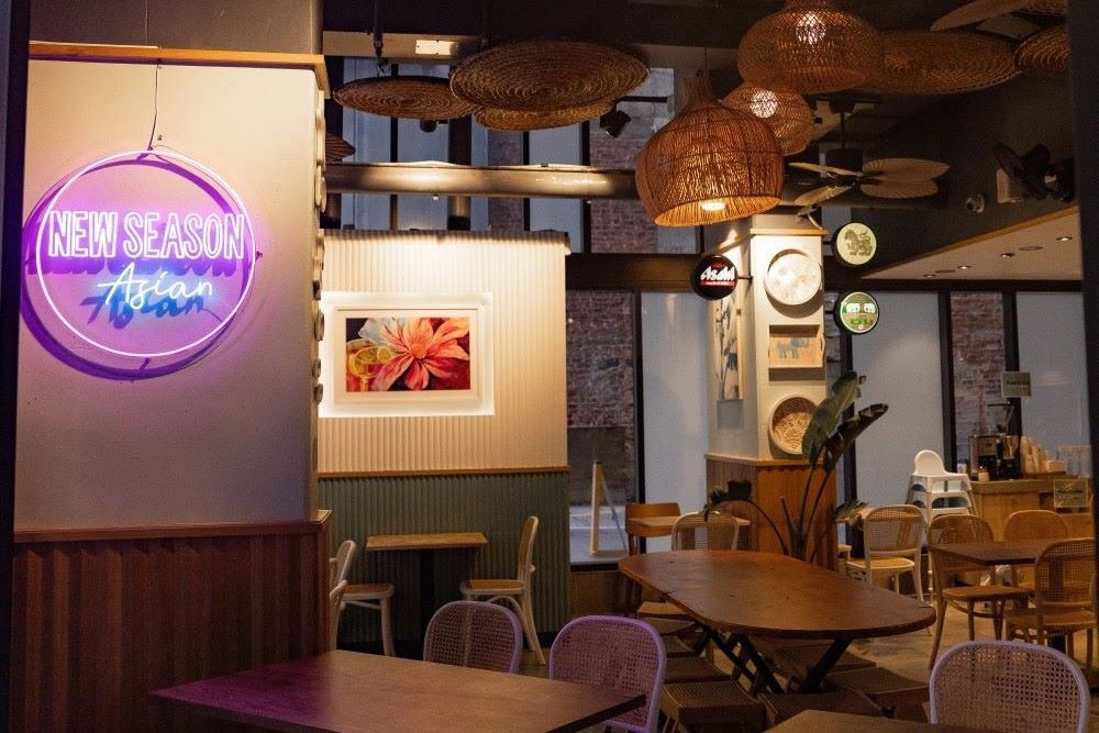 Tables and chairs inside New Season Asian, Brisbane at night