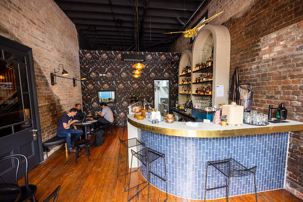 Men sitting at a table next to bar inside Fables Bar & Cafe Woolloongabba