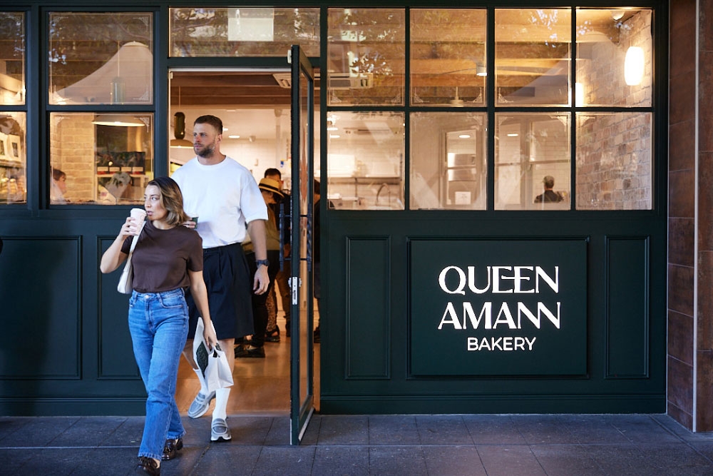 People walking out of Queen Amann Bakery