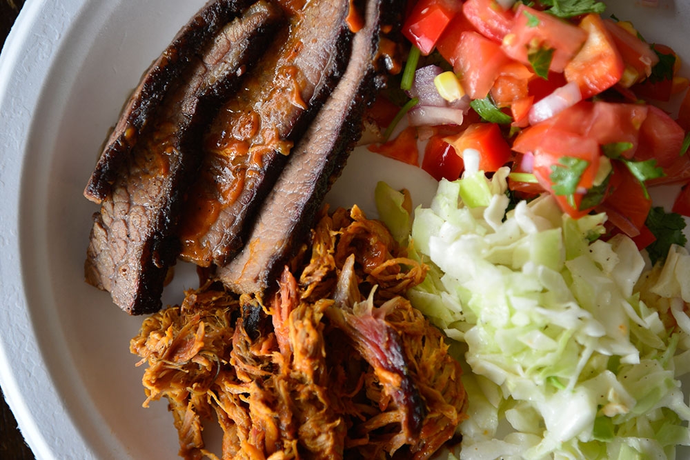 Meat and salad on a plate at Bluegrass BBQ Smokehouse at Hudson Corner