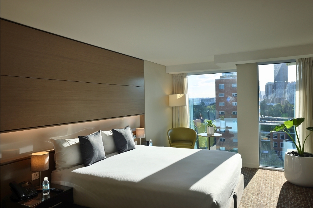 Bed in room at The Point Brisbane Hotel