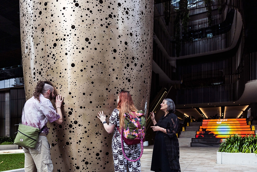 People with sculpture at Queens Wharf Precinct Public Art Tour