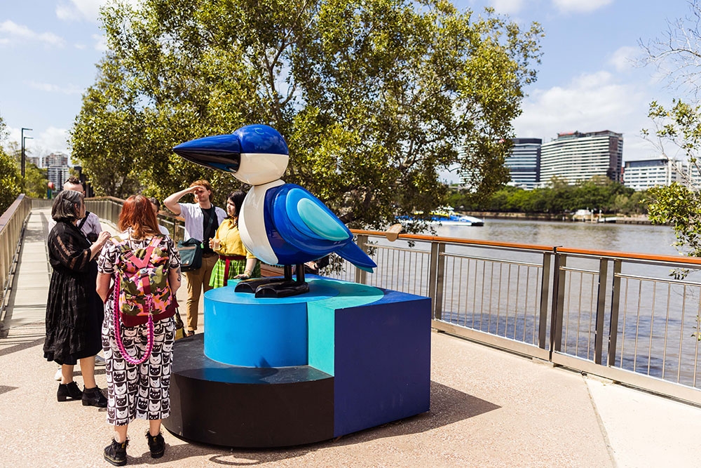People with bird sculpture Queens Wharf Precinct Public Art Tour