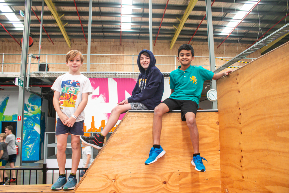 Boys sitting on slide at Urban Xtreme