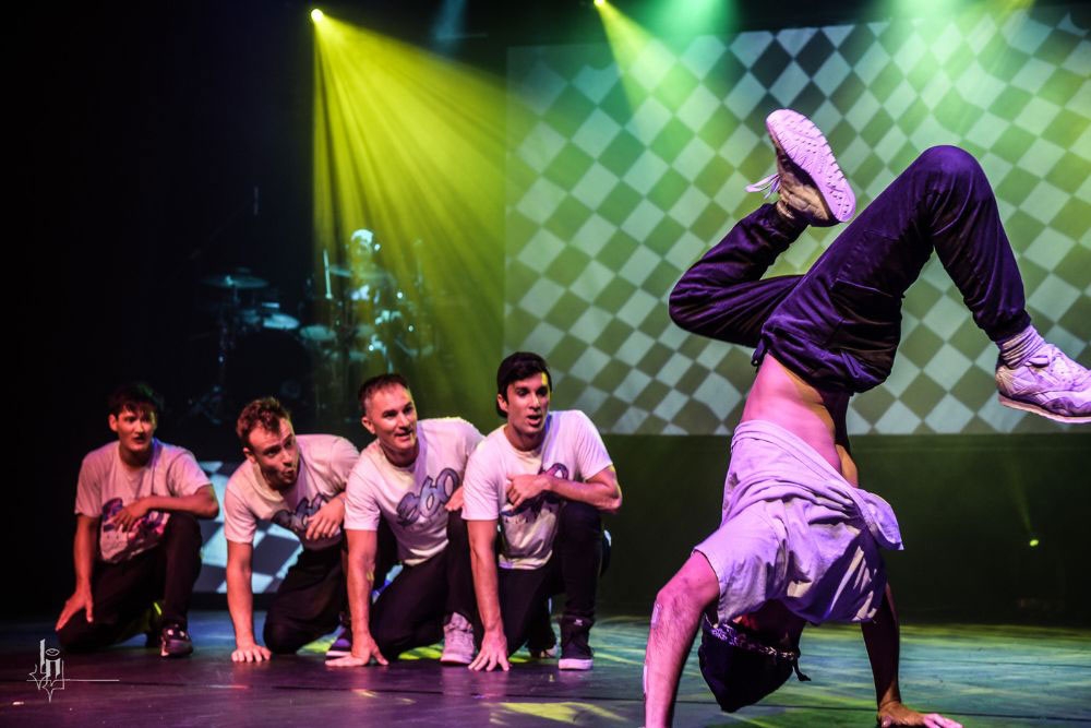 Performers breakdancing on stage 360-ALLSTARS