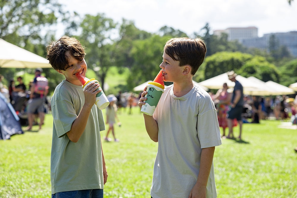 Two children with gelatos at the Easter Weekend at Roma Street Parkland