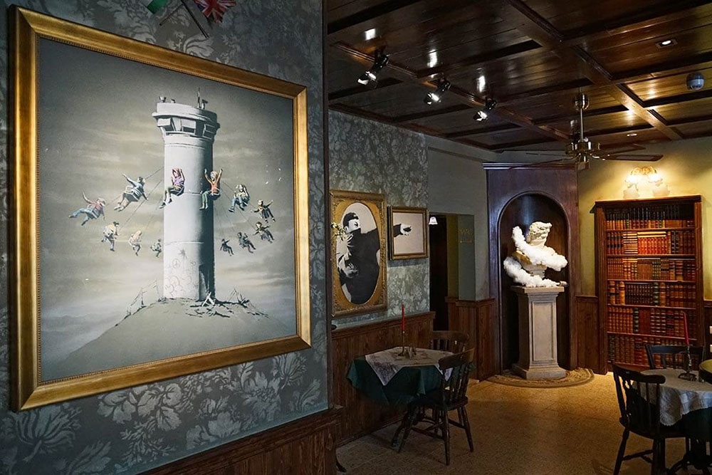 Walled off hotel lobby art installation at The Art of Banksy Chapter 2 exhibition