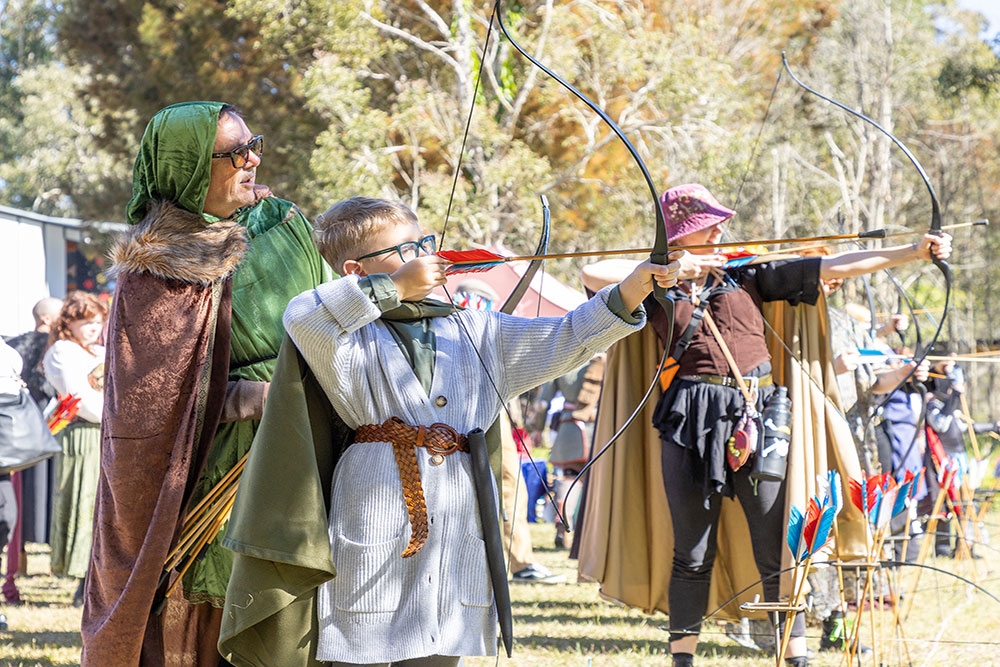 Boy doing archery at the Abbey Medieval Festival 