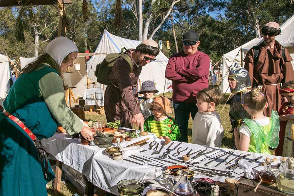 People looking at medieval tools at the Abbey Medieval Festival