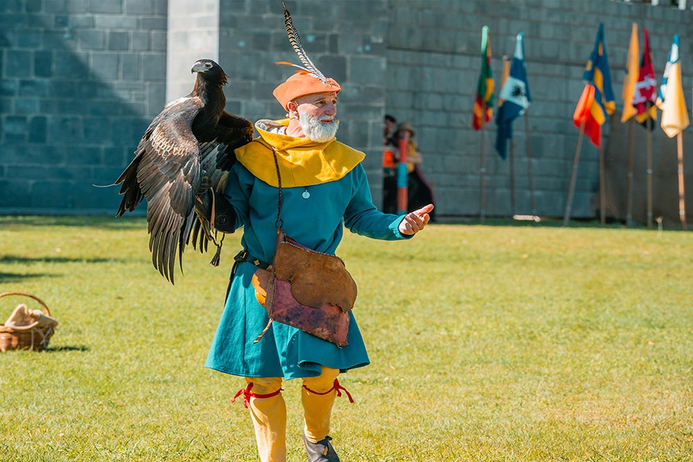 Man holding bird of prey at the Abbey Medieval Festival