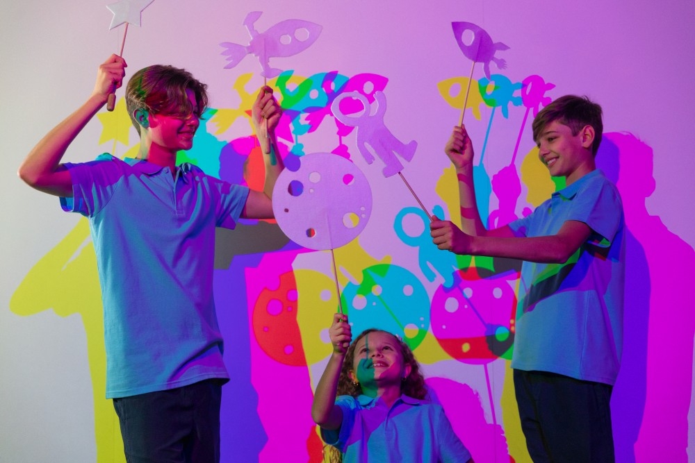 Three children playing at SparkLab, an interactive science, technology, engineering and maths (STEM) space at A Night at the Museum at Queensland Museum Kurilpa