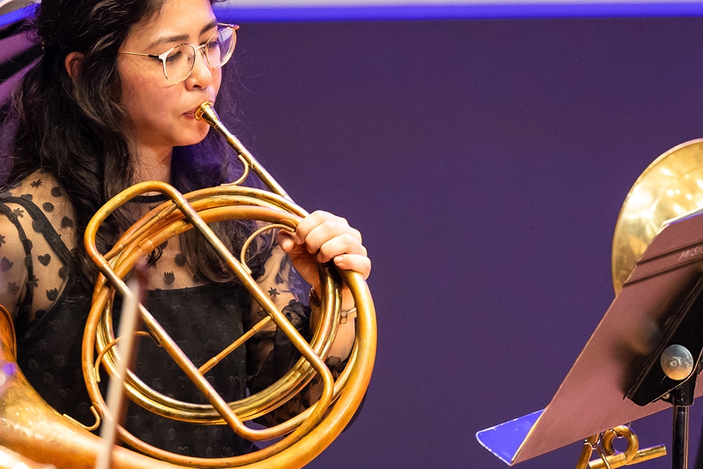 Lady playing the horn 